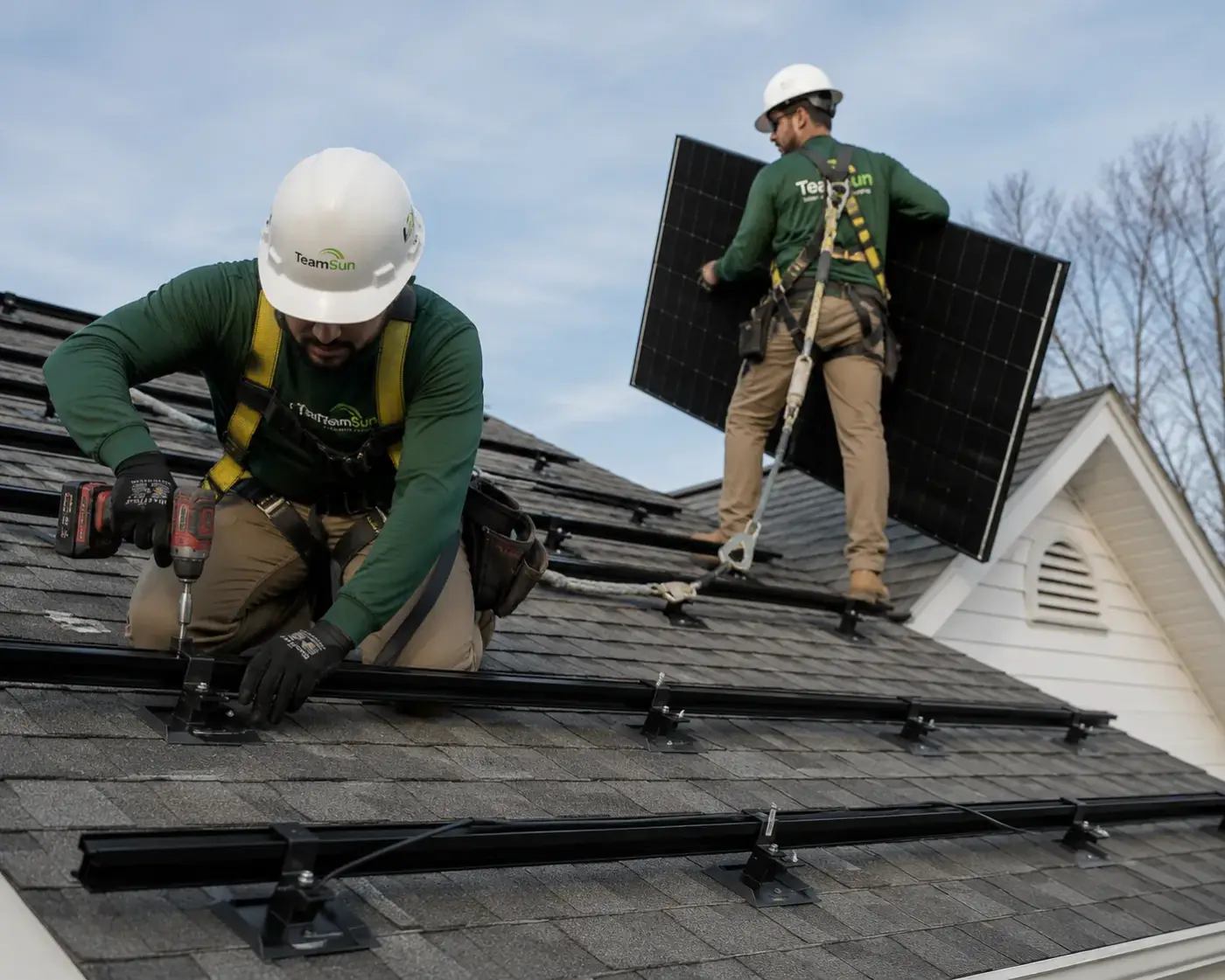 Crew installing solar panels on a roof